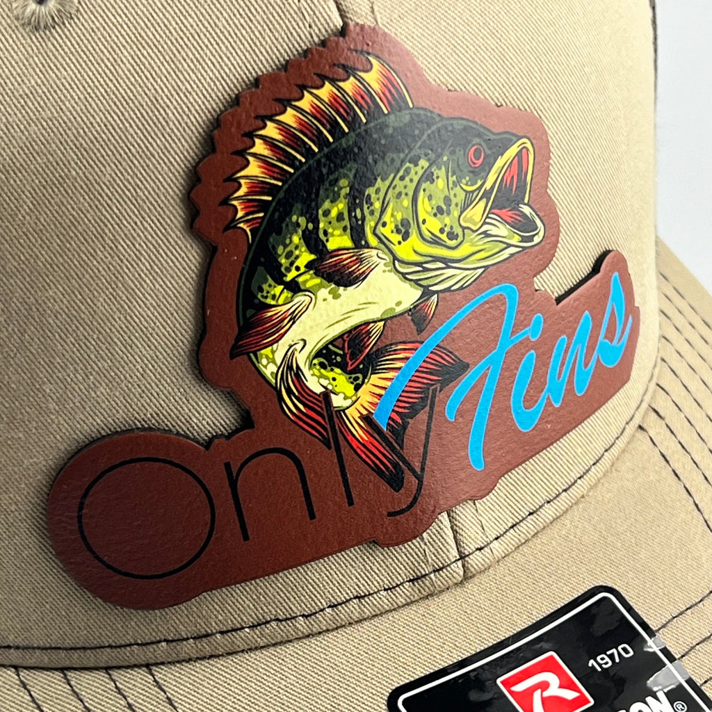 Close-up of the Only Fins bass patch on a khaki cap