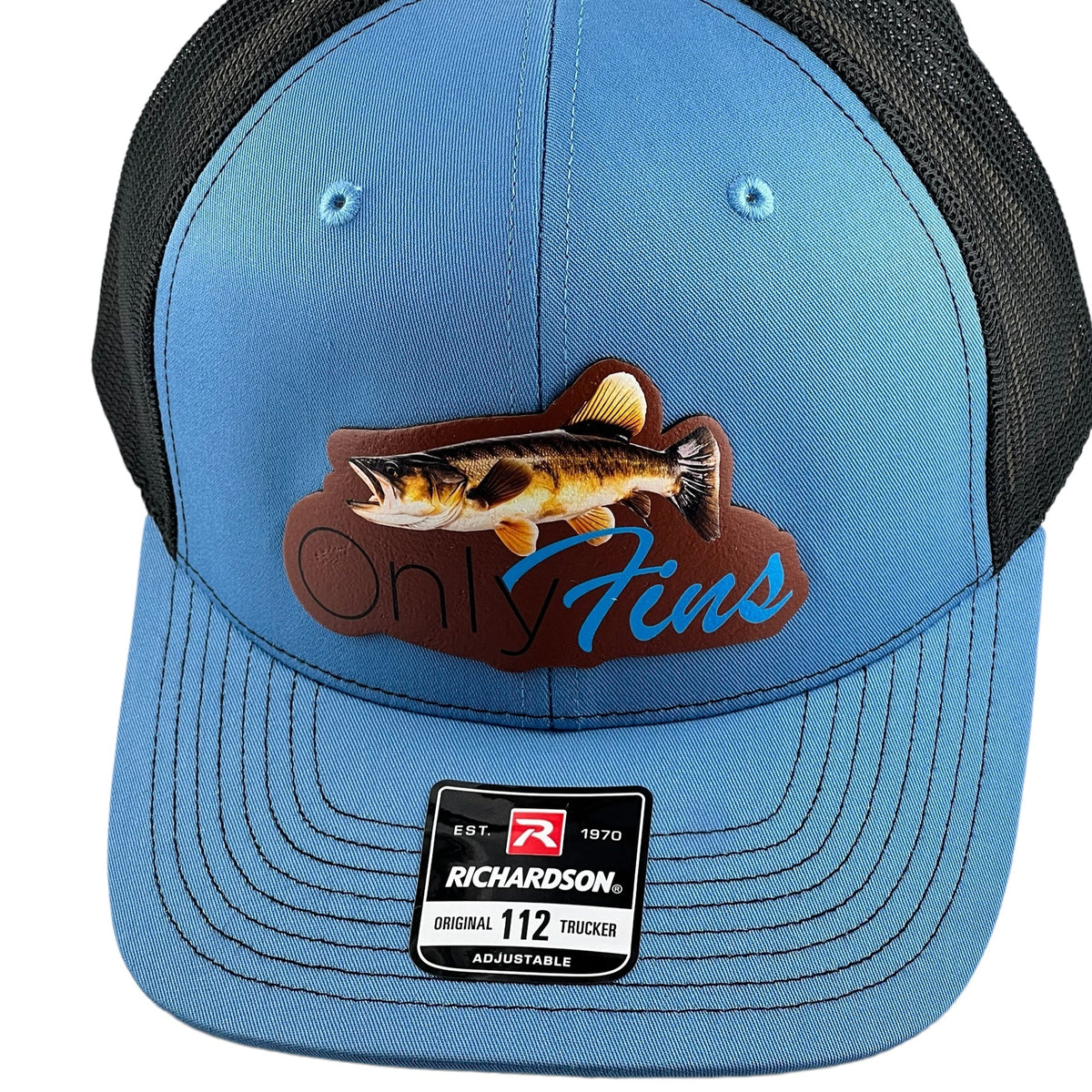 Only Fins walleye leather patch on a Columbia blue and black Richardson 112 trucker cap by HSTORM Printing