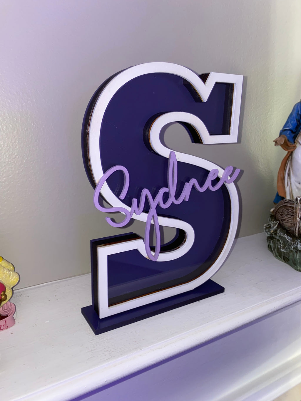 Purple letter S name piggy bank with white trim and the name Sydney